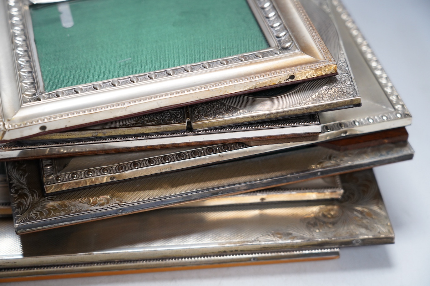 Nine assorted late 20th century 800 standard white metal mounted photograph frames, mainly Italian, including a double frame, largest 29.6cm. Condition - poor to fair